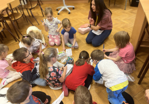 Dzieci siedzą na podłodze